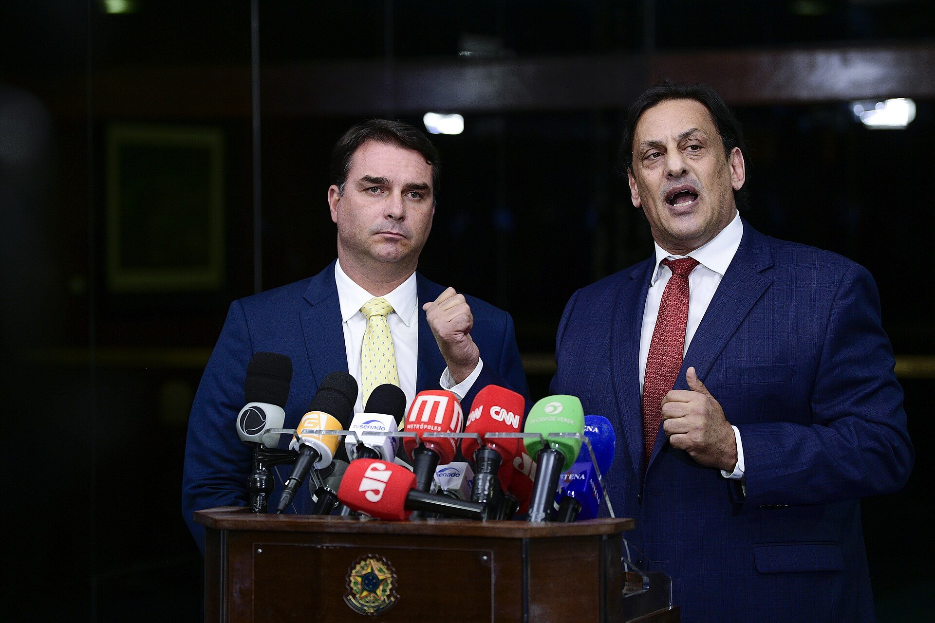 Brazilian Sen. Flávio Bolsonaro, left, and attorney Frederick Wassef speak to reporters at the Federal Senate in Brasília