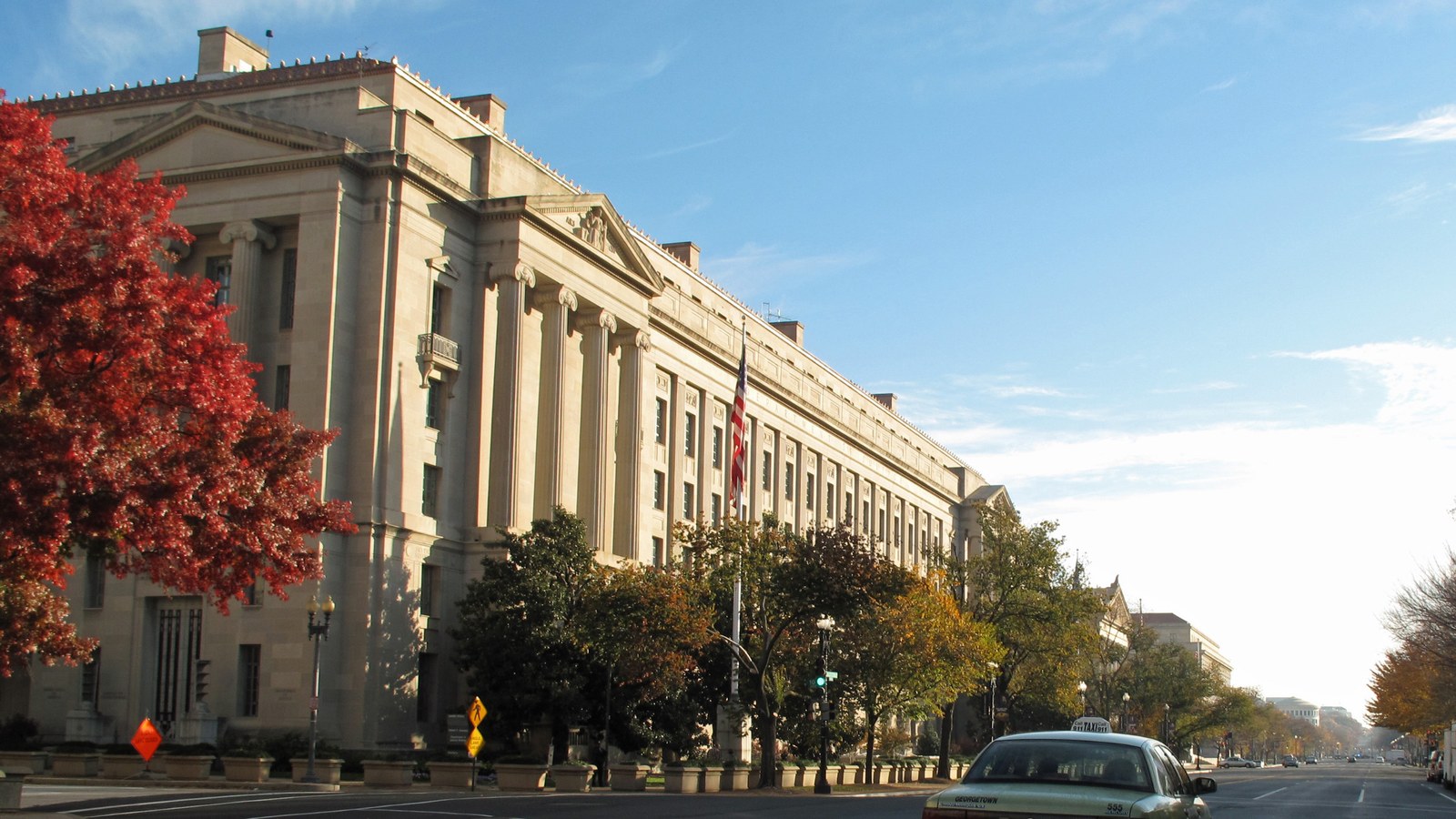The Robert F. Kennedy Department of Justice Building in Washington, D.C., on an autumn day.