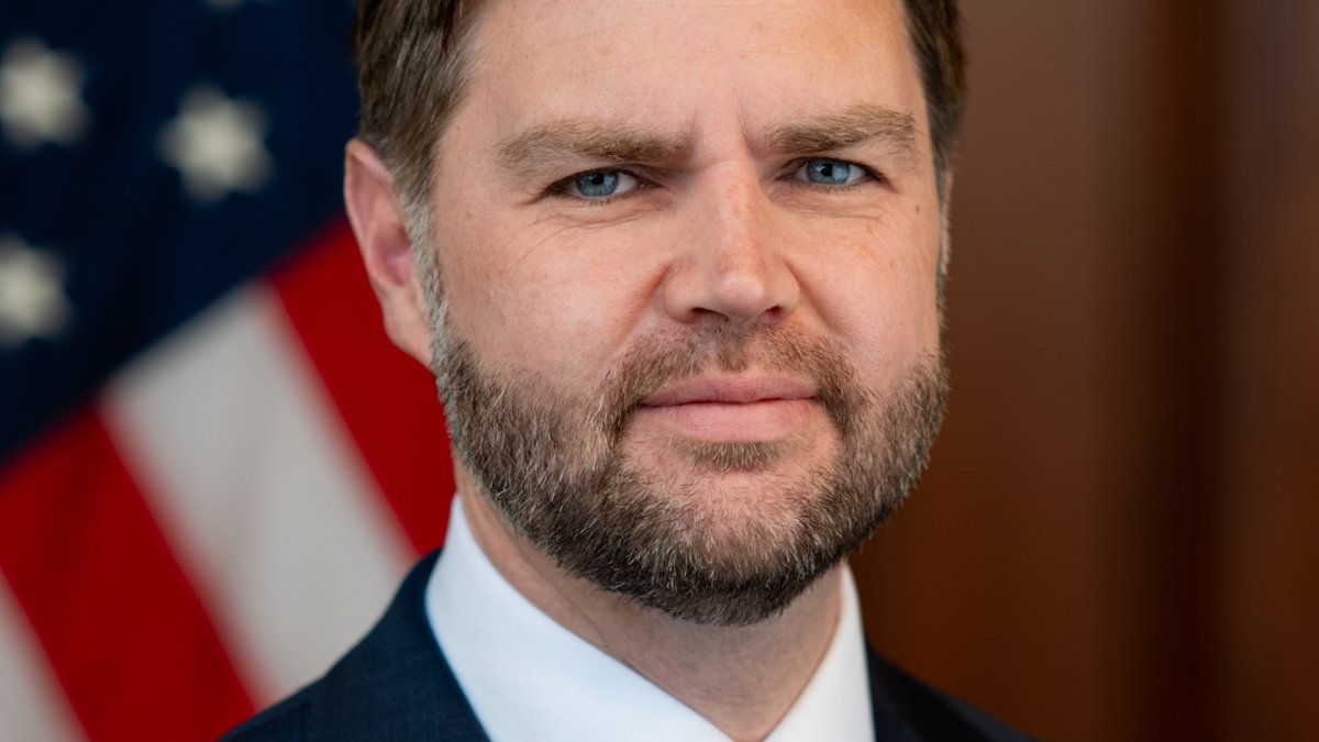Official portrait of Vice President JD Vance in front of an American flag